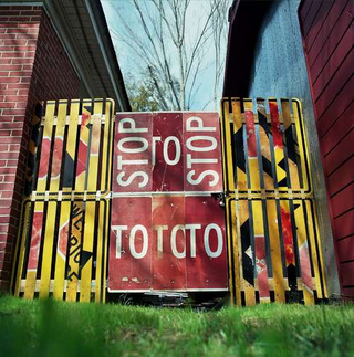 Illustration for article titled A Fence Made from Road Signs